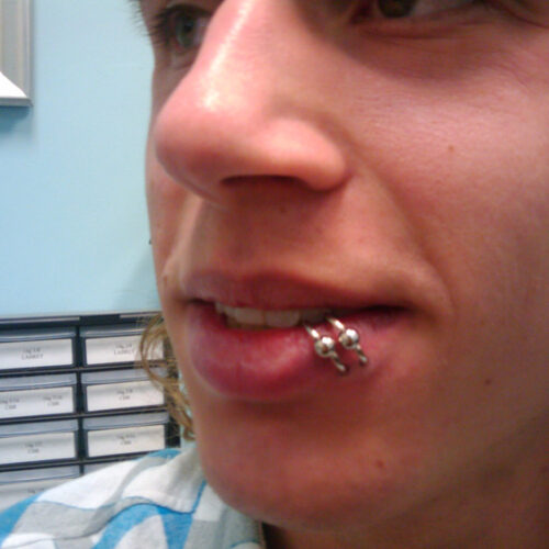 Double lip hoop ear piercing by Brandon Bohlman at Cactus Tattoo in Mankato