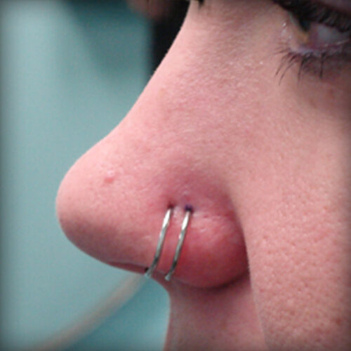 Double nostril hoop piercing by Brandon Bohlman at Cactus Tattoo in Mankato