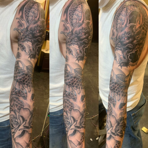 Full sleeve dragon tattoo by Rob Foster at Cactus Tattoo