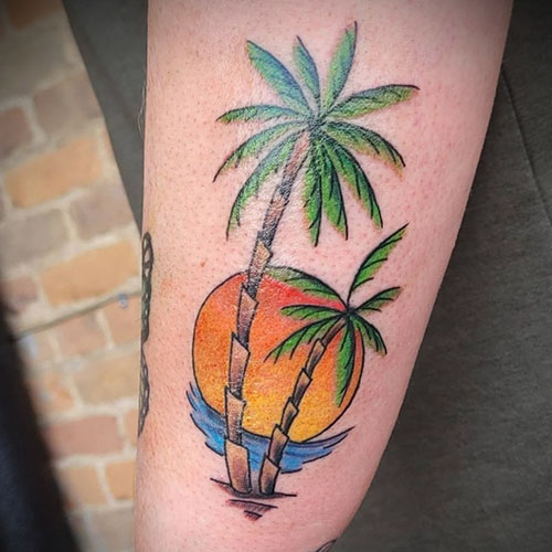 Palm trees and sunset tattoo by Chris Dorn at Cactus Tattoo in Mankato