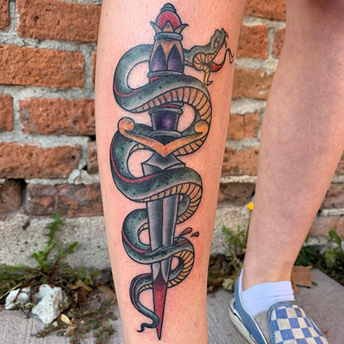 Snake and knife on leg tattoo by Rob Foster at Cactus Tattoo in Mankato