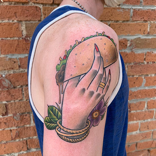 Lady holding taco shoulder tattoo by Rob Foster at Cactus Tattoo in Mankato